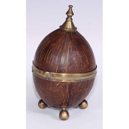 228 - An early 20th century coconut cup and cover, knop finial, bun feet, 18cm high