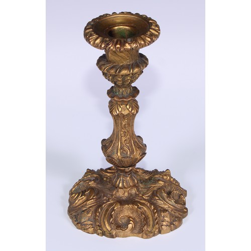 499 - A pair of Rococo ormolu candlesticks, cast with flowering C-scrolls, detachable nozzles, 17cm high, ... 