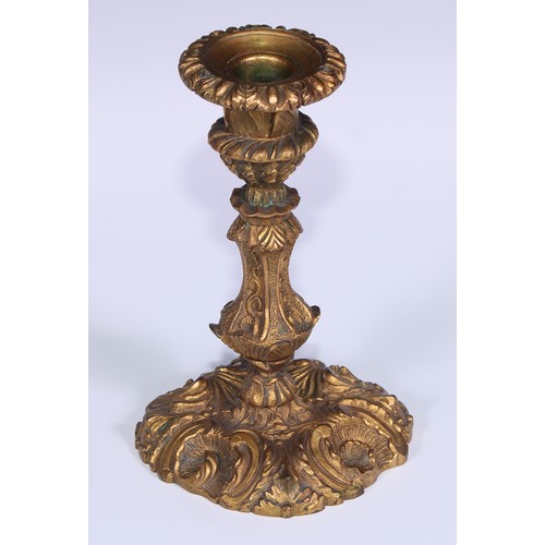 499 - A pair of Rococo ormolu candlesticks, cast with flowering C-scrolls, detachable nozzles, 17cm high, ... 