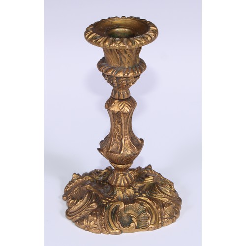 499 - A pair of Rococo ormolu candlesticks, cast with flowering C-scrolls, detachable nozzles, 17cm high, ... 