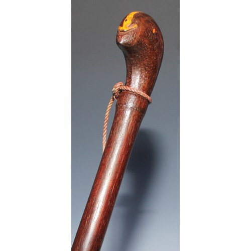 520 - Tribal Art - a hardwood staff, probably Indonesian, stylised bird head pommel, the shaft carved with... 