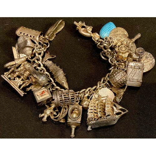 527 - A silver charm bracelet and assorted charms, including birdcage, enamelled blue heart, imp, galleon,... 