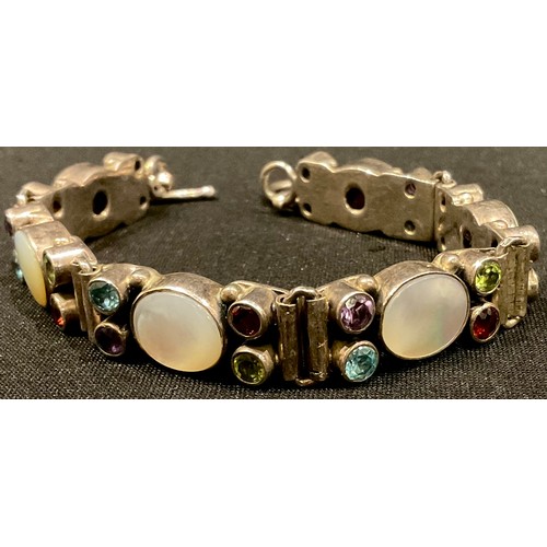 547 - An ornate Arts and Crafts style white metal stone set bracelet