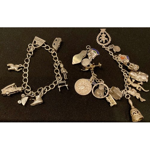 553 - A silver charm bracelet, including seventeen charms; another, including eight charms (2)