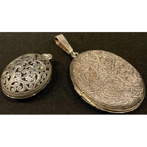 554 - A Victorian silver filigree locket; a 925 pierced silver locket