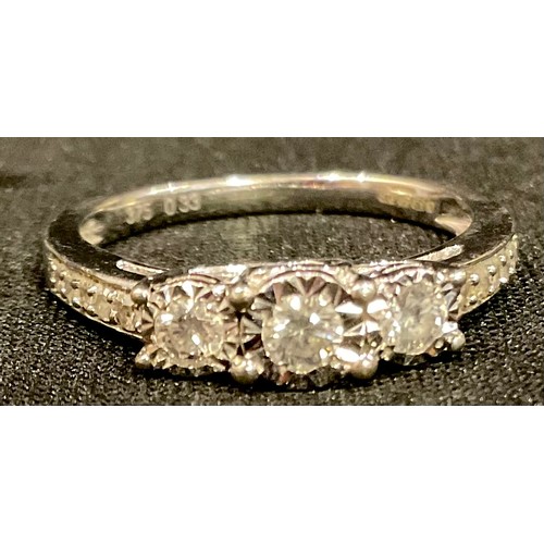 588 - A diamond three stone ring, linear set with three diamonds, 9ct white gold shank, size N, 2.8g gross