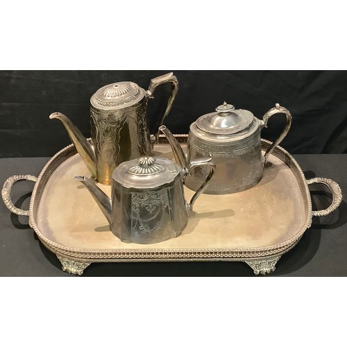 593 - An early 20th century plated two handled gallery tray, raised on four scroll feet, 64cm over handles... 