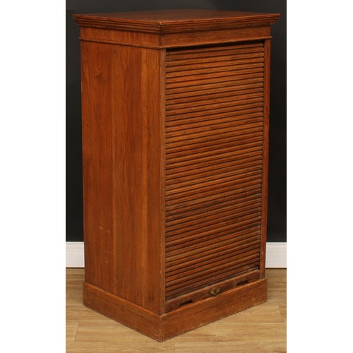 3 - An oak cased tambour front filing cabinet, rectangular top above a retractable door enclosing small ... 