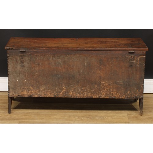 16 - A 17th century and later oak six-plank chest, hinged rectangular top with notched ends above a panel... 