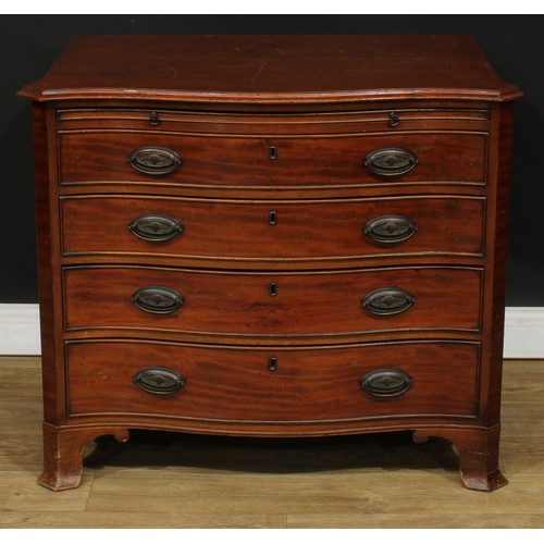 108 - A George III Revival mahogany serpentine bachelor’s chest, slightly oversailing top above a slide an... 