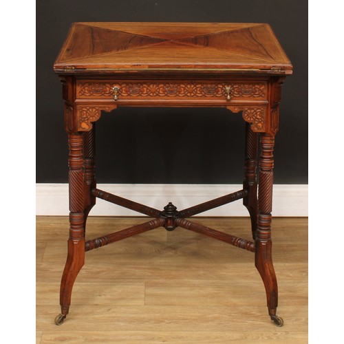 112 - An Edwardian rosewood envelope card table, hinged top above a long frieze drawer, the frieze applied... 