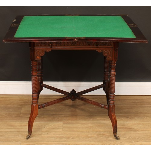 112 - An Edwardian rosewood envelope card table, hinged top above a long frieze drawer, the frieze applied... 