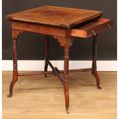 112 - An Edwardian rosewood envelope card table, hinged top above a long frieze drawer, the frieze applied... 