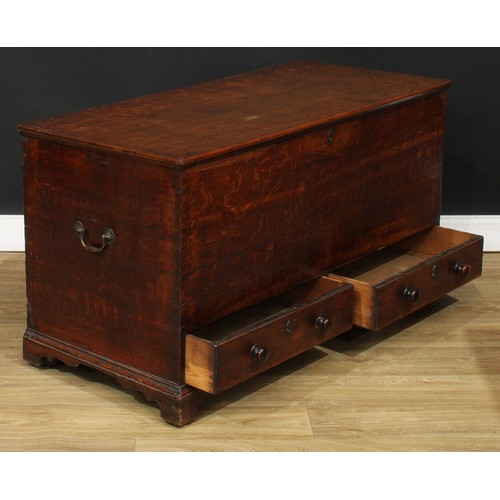 116 - A George III oak mule chest, hinged top enclosing a till, above two short drawers, skirted base, bra... 