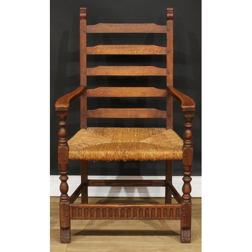 117 - A set of six Rupert Griffiths Monastic Woodcraft oak ladder back dining chairs, comprising four side... 