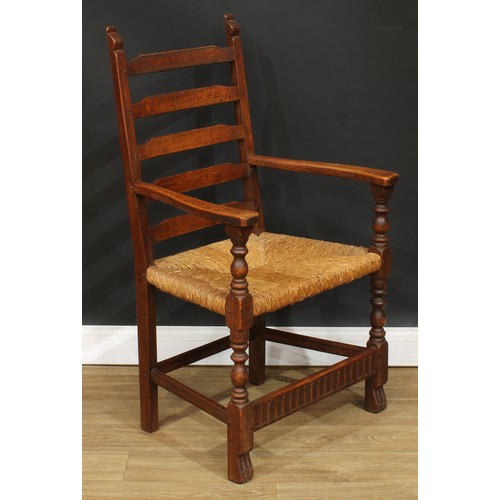 117 - A set of six Rupert Griffiths Monastic Woodcraft oak ladder back dining chairs, comprising four side... 