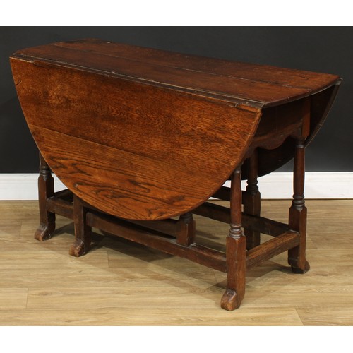 118 - An 18th century oak gateleg table, oval top with fall leaves, turned supports, 71cm high, 45cm openi... 