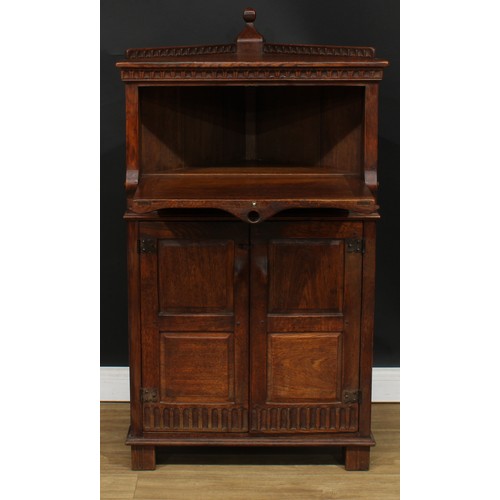 119 - A Rupert Griffiths Monastic Woodcraft oak drinks cabinet, 131cm high, 73cm wide, 50cm deep