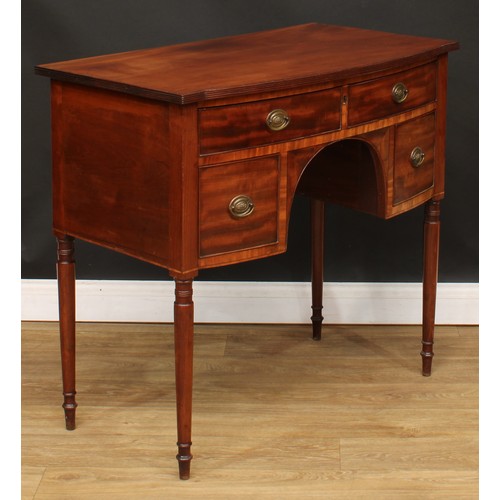 201 - A George III mahogany kneehole dressing or serving table, slightly oversailing bow-centre top with r... 