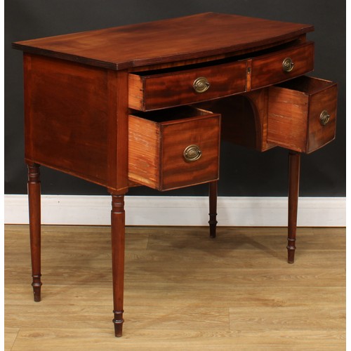 201 - A George III mahogany kneehole dressing or serving table, slightly oversailing bow-centre top with r... 