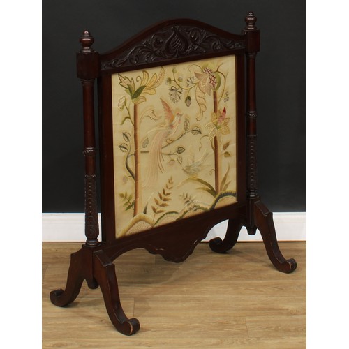 207 - A mahogany fire screen, arched cresting carved in the Art Nouveau taste, woolwork banner, stiff acan... 