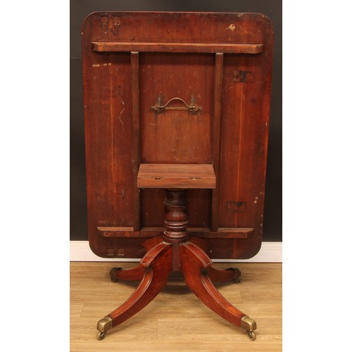 210 - A Regency mahogany breakfast table, rounded rectangular tilting top, turned column, sabre legs, bras... 