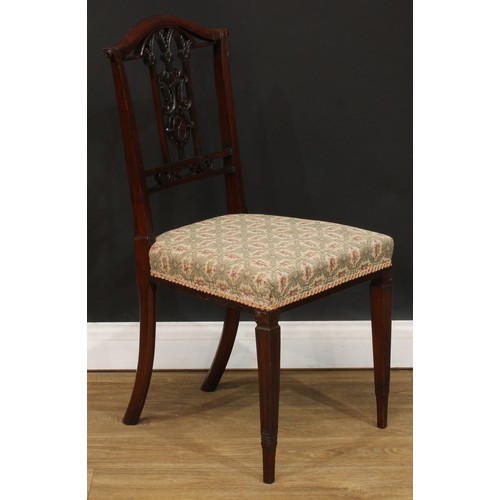 211 - A set of four Edwardian dining chairs, each architectural-form splat carved with leaves and scrolls,... 