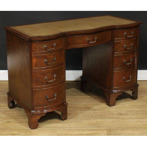 218 - A Bevan Funnell Reprodux mahogany serpentine desk, in the George III taste, 75.5cm high, 115.5cm wid... 