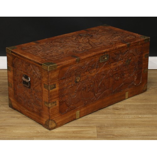 220 - A Chinese inspired brass mounted camphor lined chest or trunk, the exterior carved with dragons, 44.... 