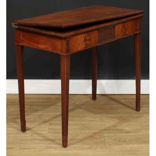 304 - A mahogany tea table, hinged crossbanded rectangular top above a deep frieze centred by a nulled tab... 