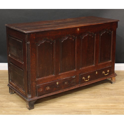 310 - A George III oak mule chest, hinged cover enclosing three small drawers, the front with four raised ... 