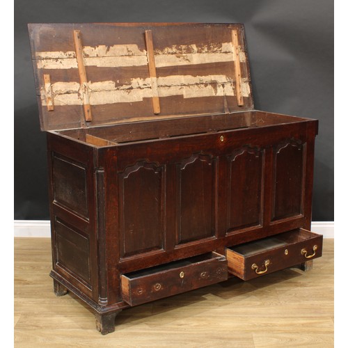 310 - A George III oak mule chest, hinged cover enclosing three small drawers, the front with four raised ... 