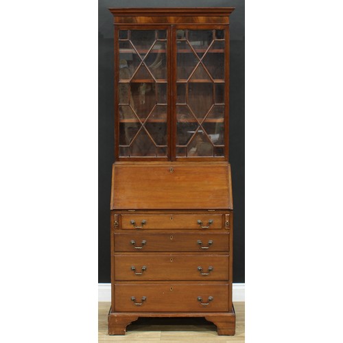 689 - An early 20th century mahogany bureau bookcase, of narrow proportions, outswept cornice above a pair... 