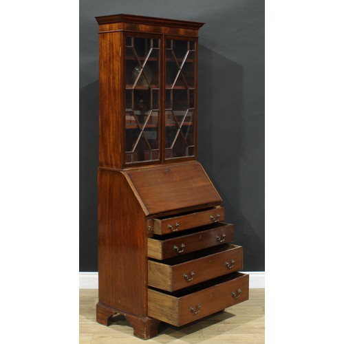 689 - An early 20th century mahogany bureau bookcase, of narrow proportions, outswept cornice above a pair... 