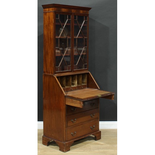 689 - An early 20th century mahogany bureau bookcase, of narrow proportions, outswept cornice above a pair... 