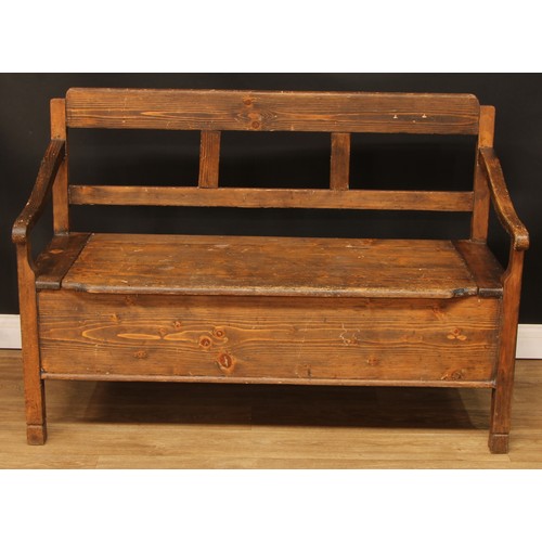 693 - A pine box settle or bench, removable seat, formerly hinged, 93.5cm high, 134.5cm wide, the seat pan... 