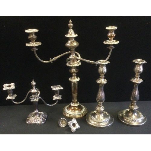 111 - An E.P on Copper. three light two branch table candelabrum, 51cm high;  a pair of similar candlestic... 