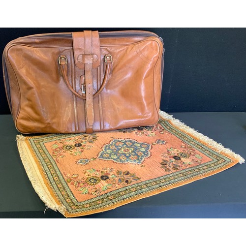 133 - A G Novi leather holdall case, 71cm wide, 49cm high;  a Persian Seiden Ghim silk prayer mat, 81cm x ... 