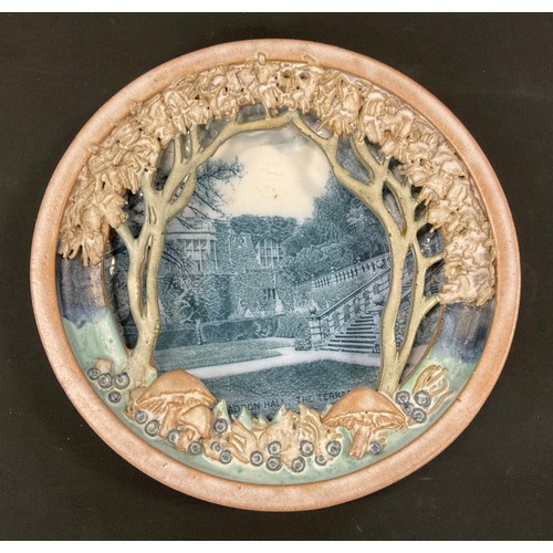 178 - An unusual Briggs & Company Haddon Hall wall plaque, mounted within pottery frame, the mount moulded... 