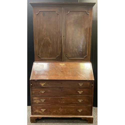 206 - A George III  mahogany bureau bookcase, the moulded cornice above two panelled doors, the base with ... 