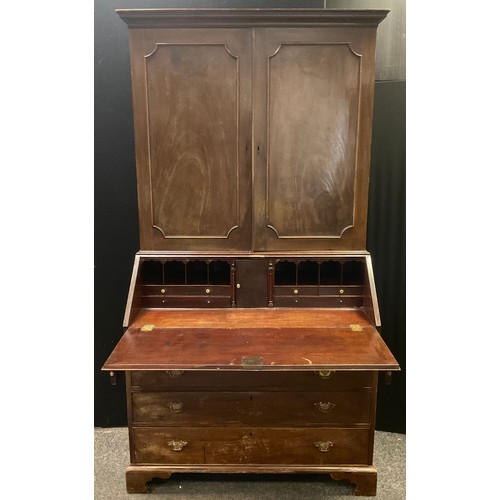 206 - A George III  mahogany bureau bookcase, the moulded cornice above two panelled doors, the base with ... 