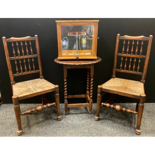 218 - A pair of 19th century spindle back chairs;  oval occasional table;  scientific scale (4)