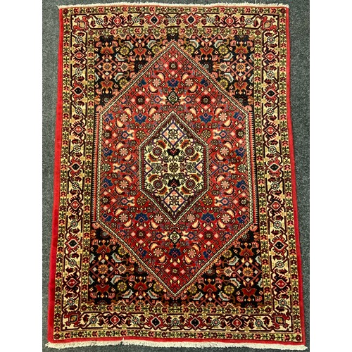 229 - A Bidjar rug / carpet, intricately woven with stylised floral motifs in shades of red, indigo and bl... 