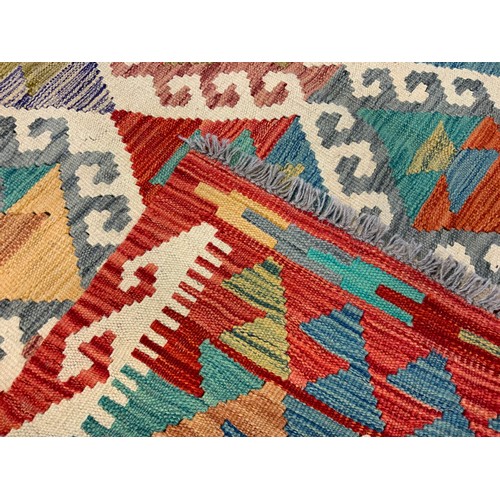 237 - An Anatolian Kilim rug / carpet, woven with an arrangement of diamonds within a field of red, turquo... 