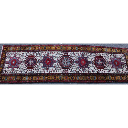 242 - A Persian hand-made Heriz runner, 332cm x 96cm