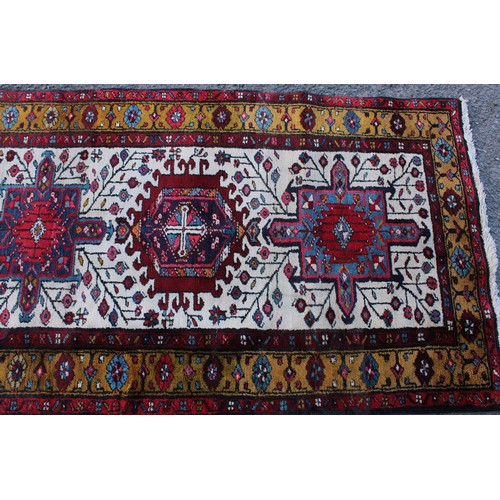 242 - A Persian hand-made Heriz runner, 332cm x 96cm