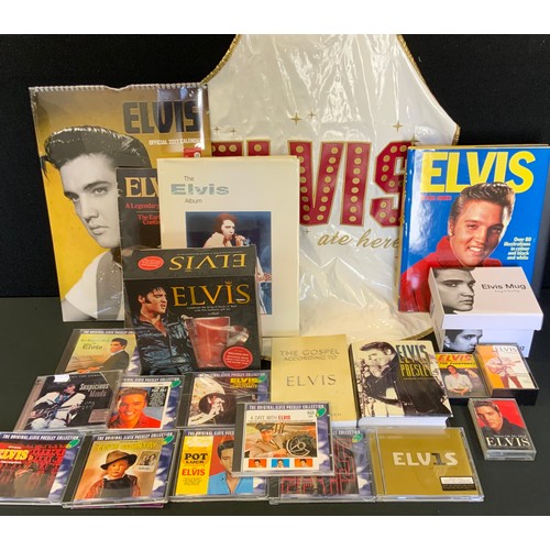 278 - Elvis Memorabilia - CD'S;  2017 calendar;  Nick Rudge - The Elvis Album;  mugs;  Elvis apron;  etc