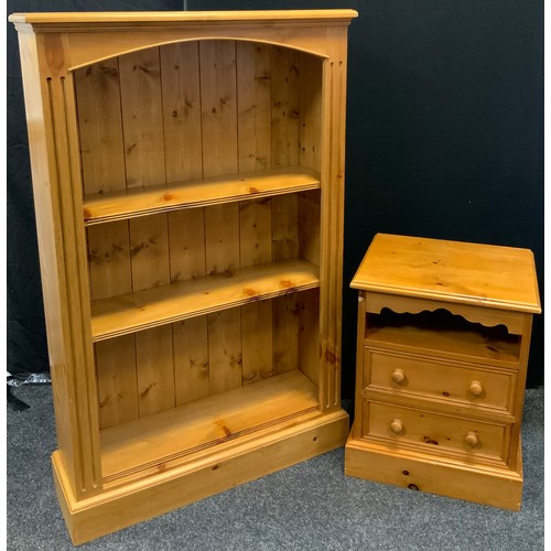 300 - A pine three tier open bookcase, 132cm high, 85cm wide, 26cm deep;  a pine bedside chest, open shelf... 