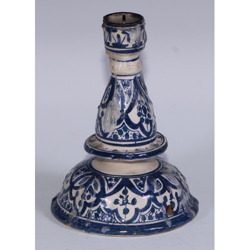 55 - An Islamic tin glazed earthenware candlestick, signed Safi and inscribed in Arabic, 15cm high