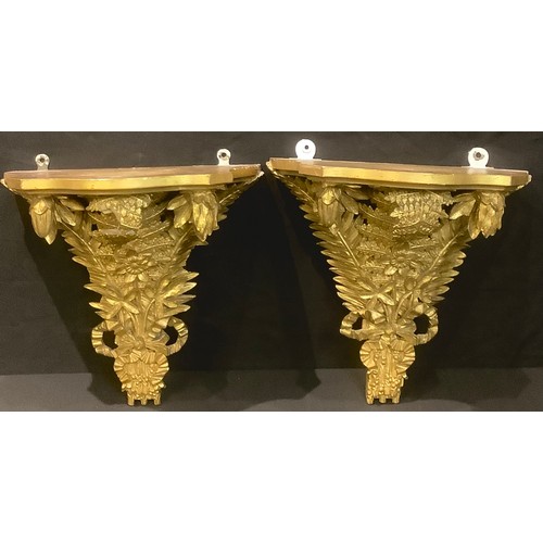 69 - A pair of Louis XIV style gold painted wall brackets, shaped serpentine plateau above ribbon tied ar... 